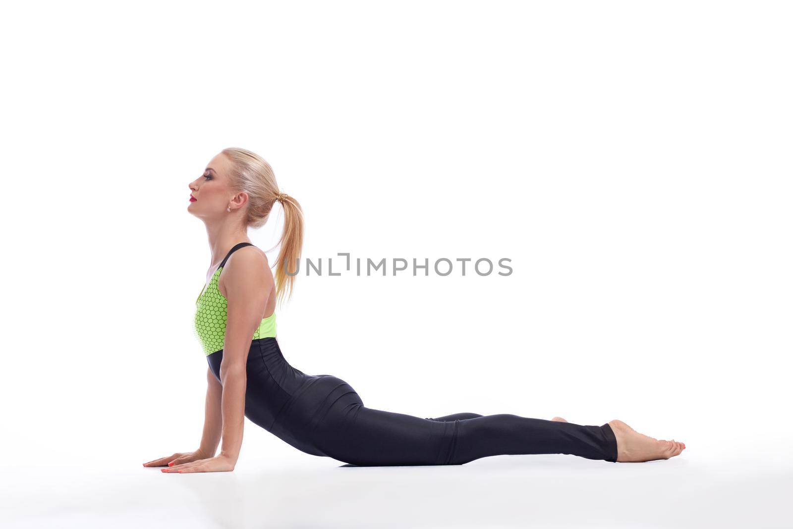 Easy yoga. Studio shot of a young fit female practicing yoga stretching her back isolated copyspace yoga healthcare fitness vitality body concept