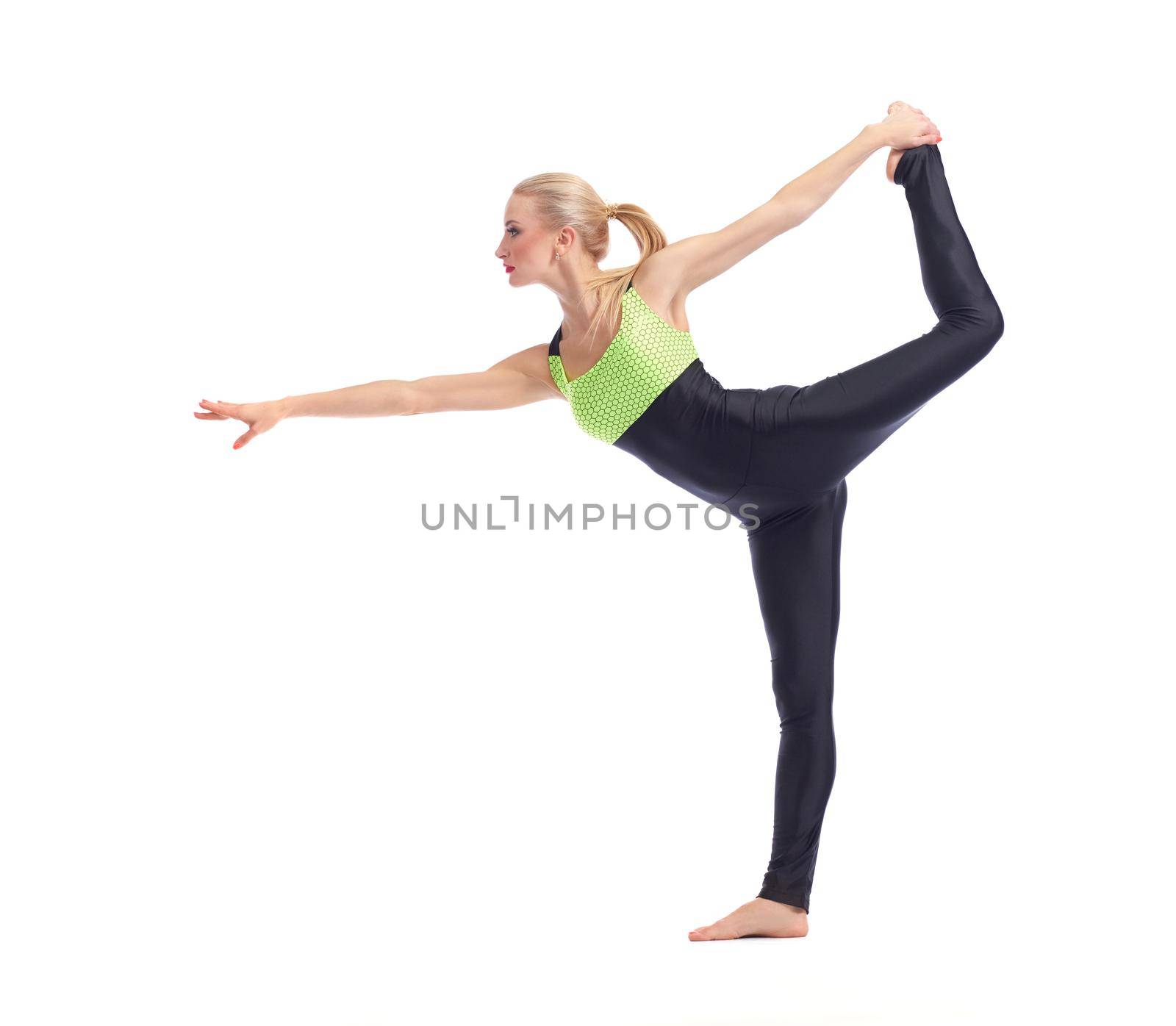 Flexible body. Full length shot of a fit young woman doing yoga against white background balancing on one leg posing gracefully copyspace