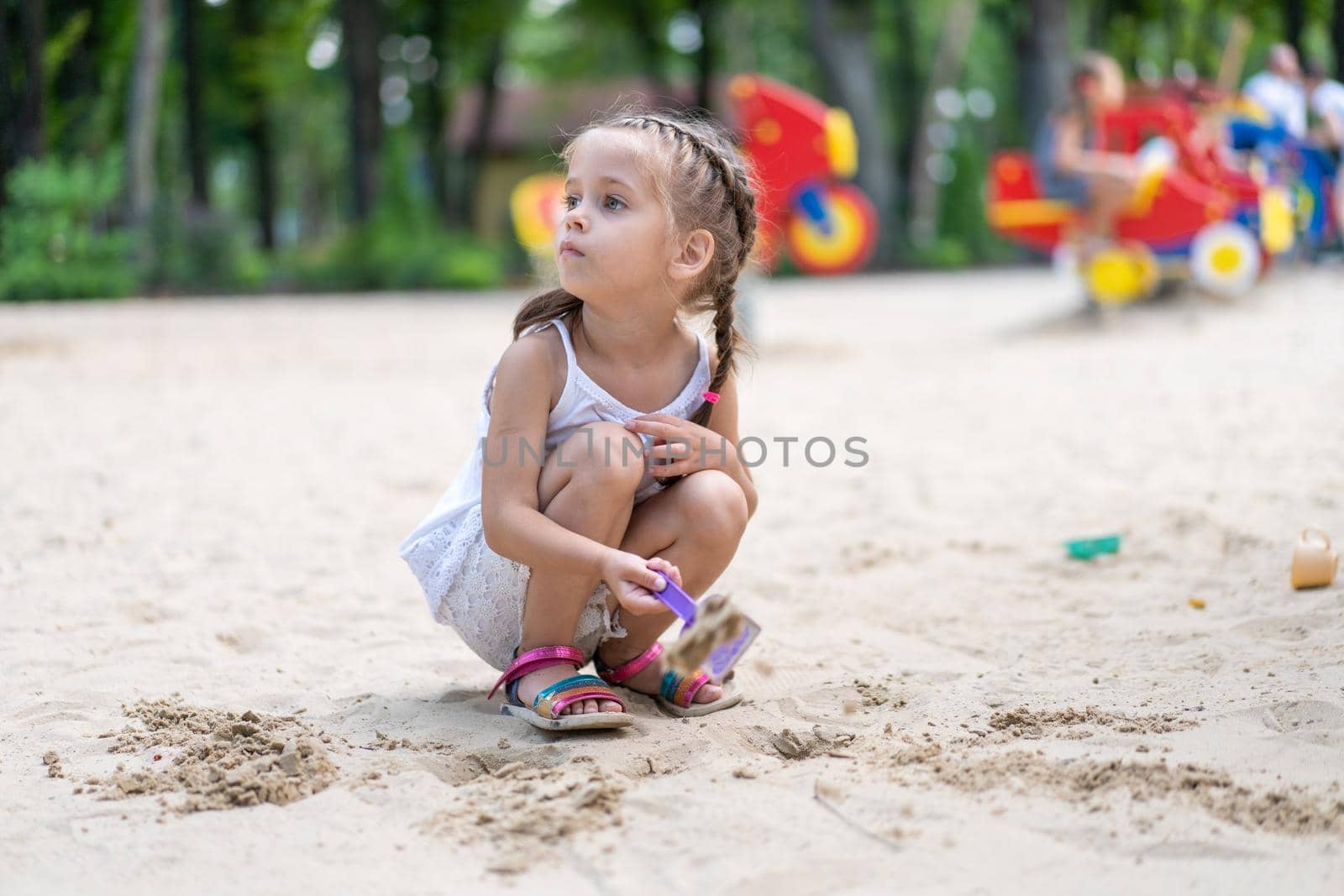 Little Girl Playing Sandbox Playground Digging Sand Shovel Building Sand Figure Summer Day by andreonegin