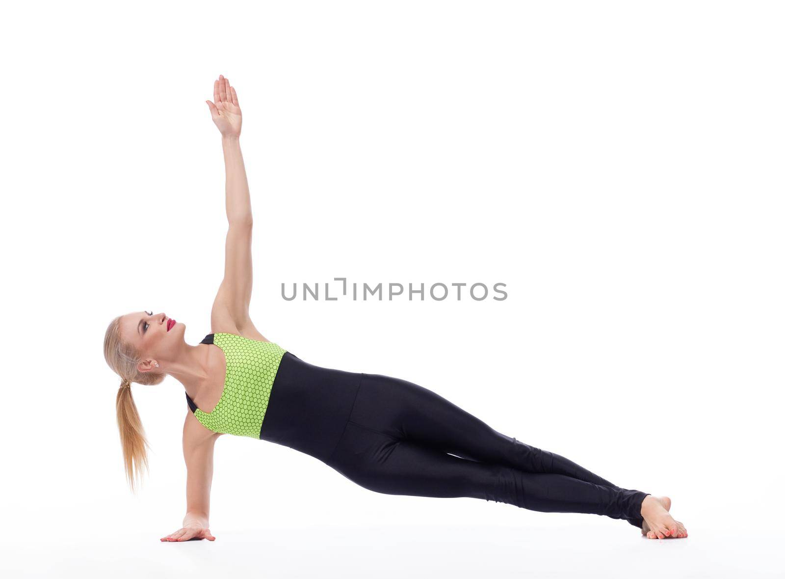 Attractive female gymnast exercising at studio by SerhiiBobyk