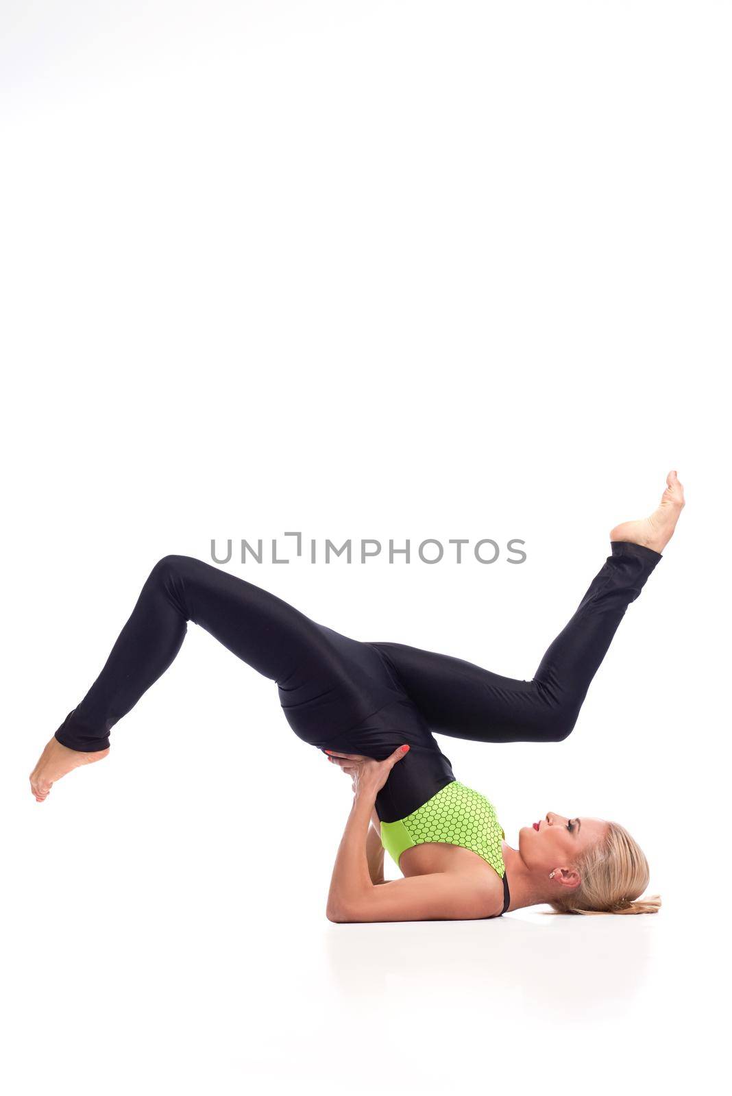 Attractive female gymnast exercising at studio by SerhiiBobyk