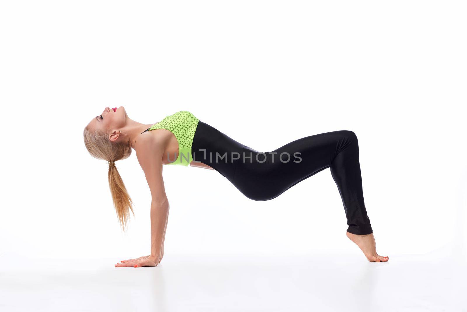 Challenging herself in sports. Portrait of a fit and toned sportswoman performing yoga at the studio isolated copyspace