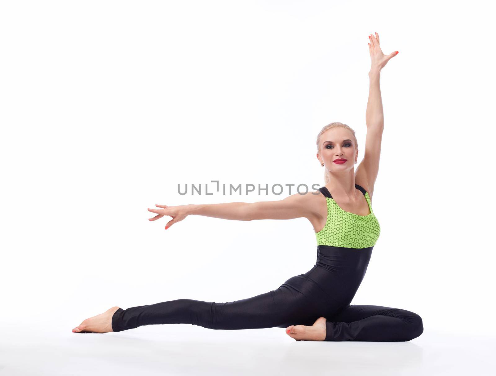 Gorgeous young woman practicing yoga sitting on the floor by SerhiiBobyk