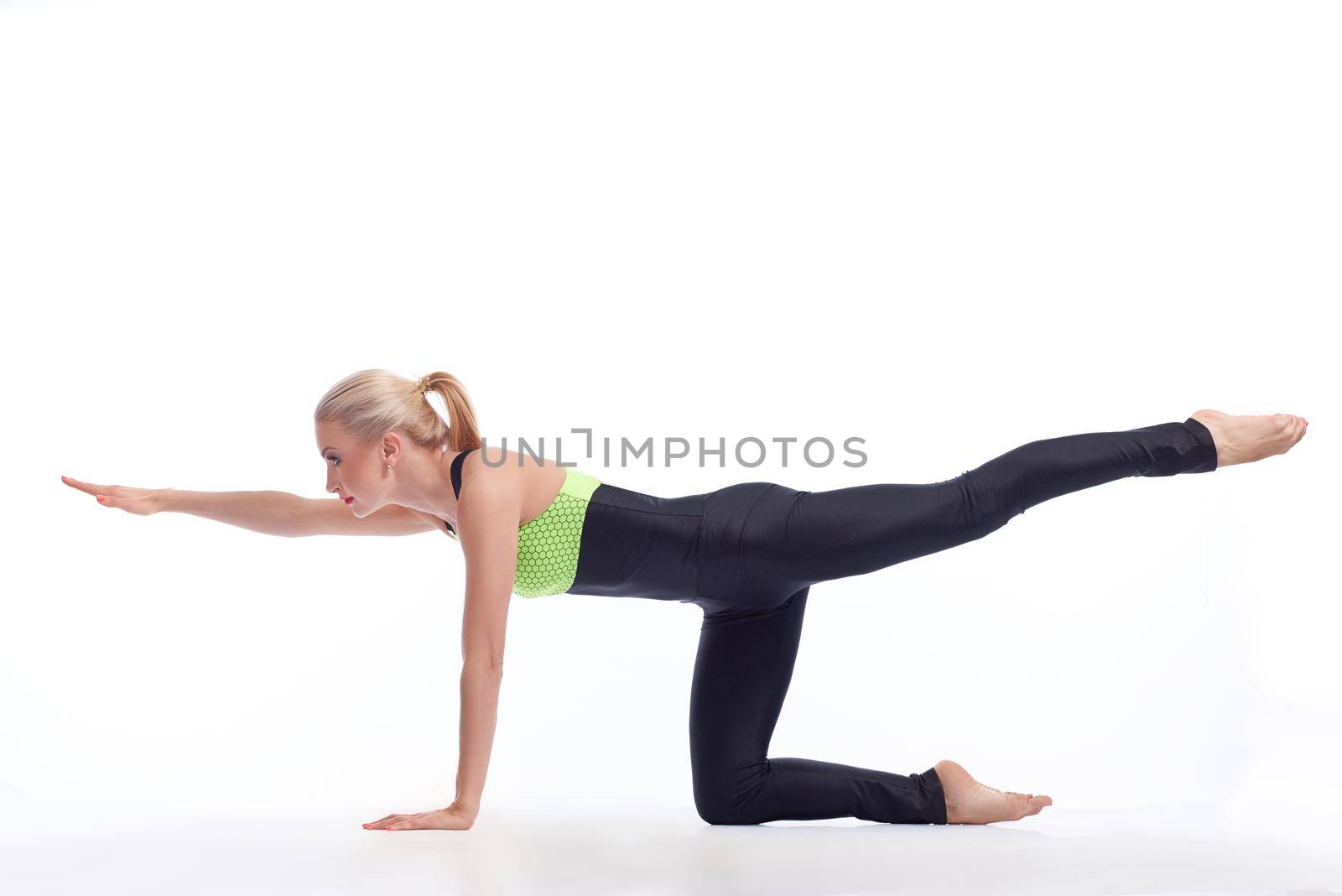 Attractive female gymnast exercising at studio by SerhiiBobyk