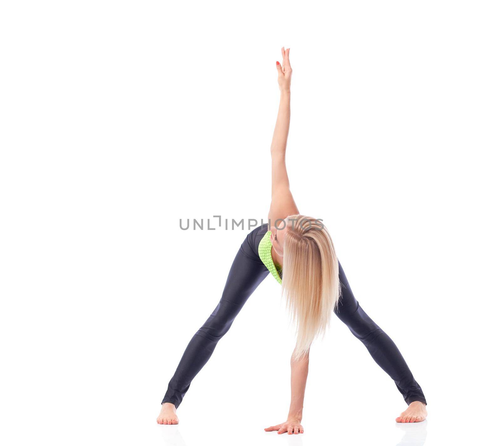 Sportive lifestyle. Fit and active young woman performing back stretching doing yoga asana at the studio isolated health stretching training concept copyspace