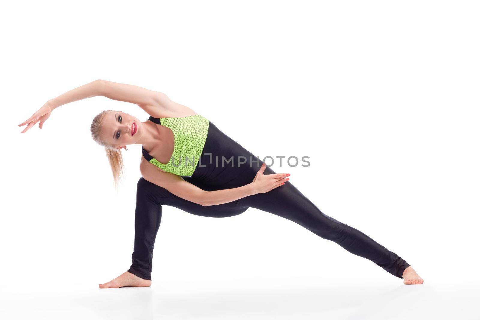 Stretching before gym. Beautiful cheerful woman smiling while stretching before exercising isolated copyspace sports gym vitality activity concept