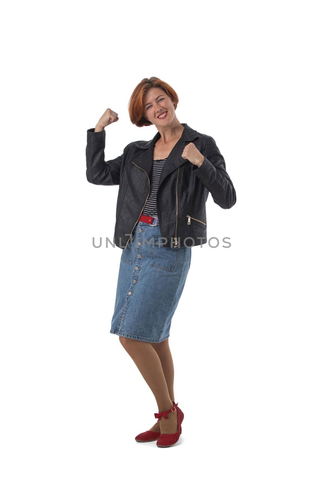 Happy woman winner in casual wear hold fists looking at camera, isolated over white background