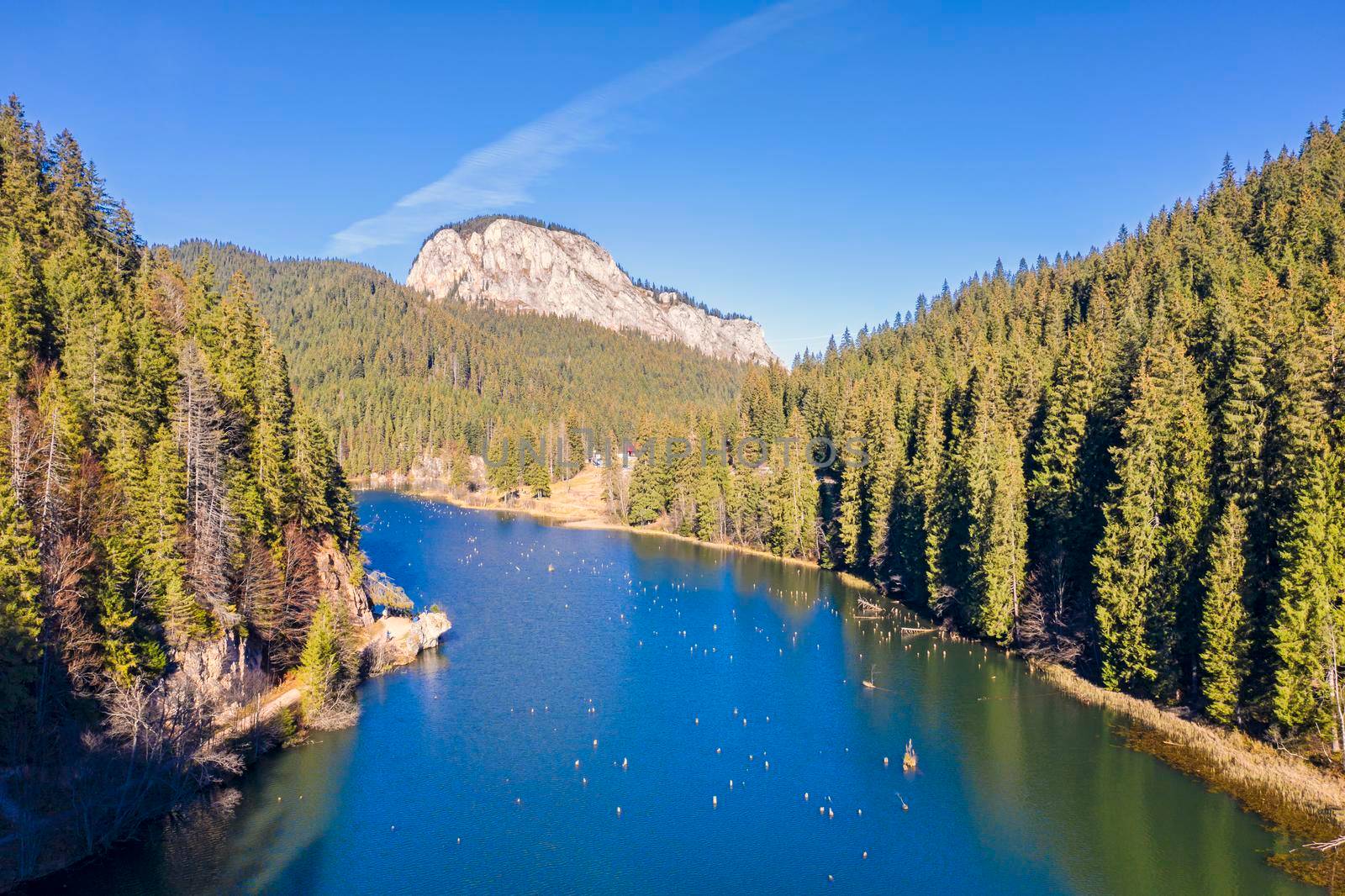 Aerial view of mountain lake in Romanian Carpathians. Red Lake is a natural dam lake in Romania located in the north-east where you can still see the tree stumps.