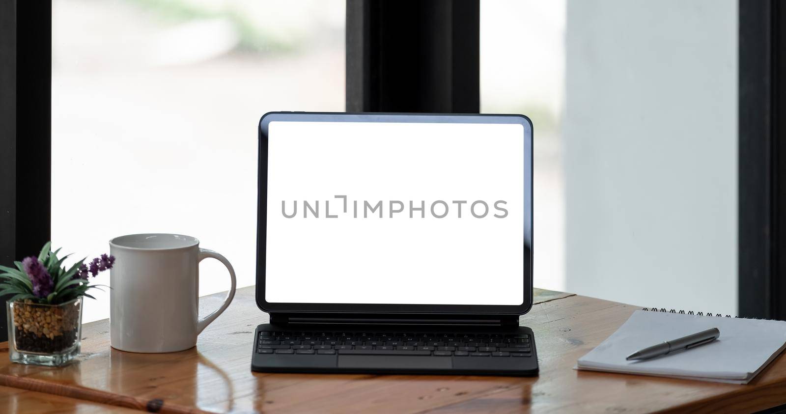 Cropped shot of blank screen tablet and office supplies in simple workspace. clipping path by nateemee