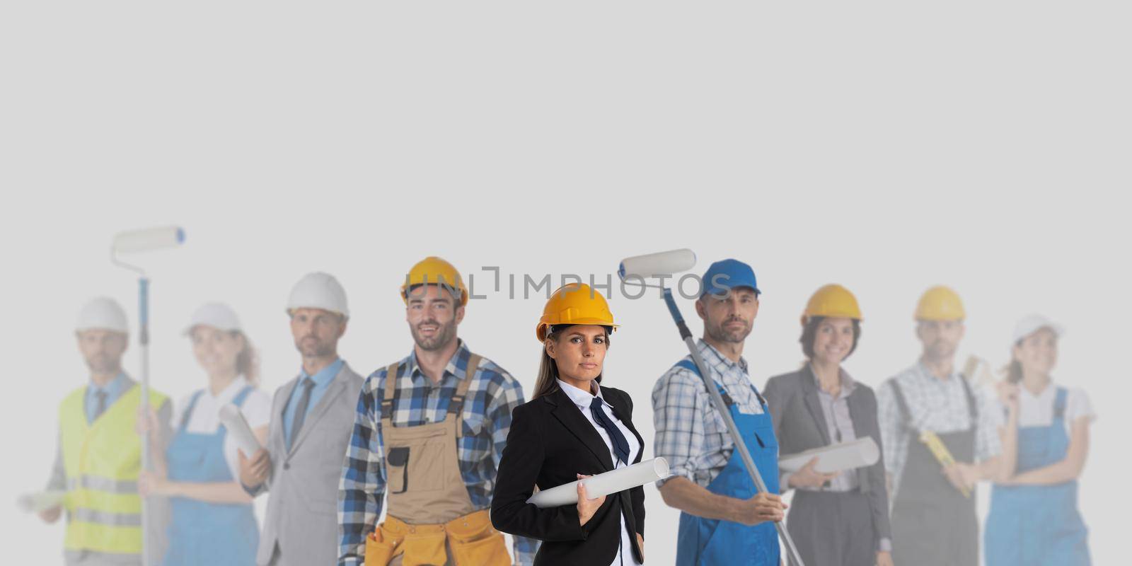 Group of industrial contractors workers people standing together on gray background, unity cooperation teamwork concept