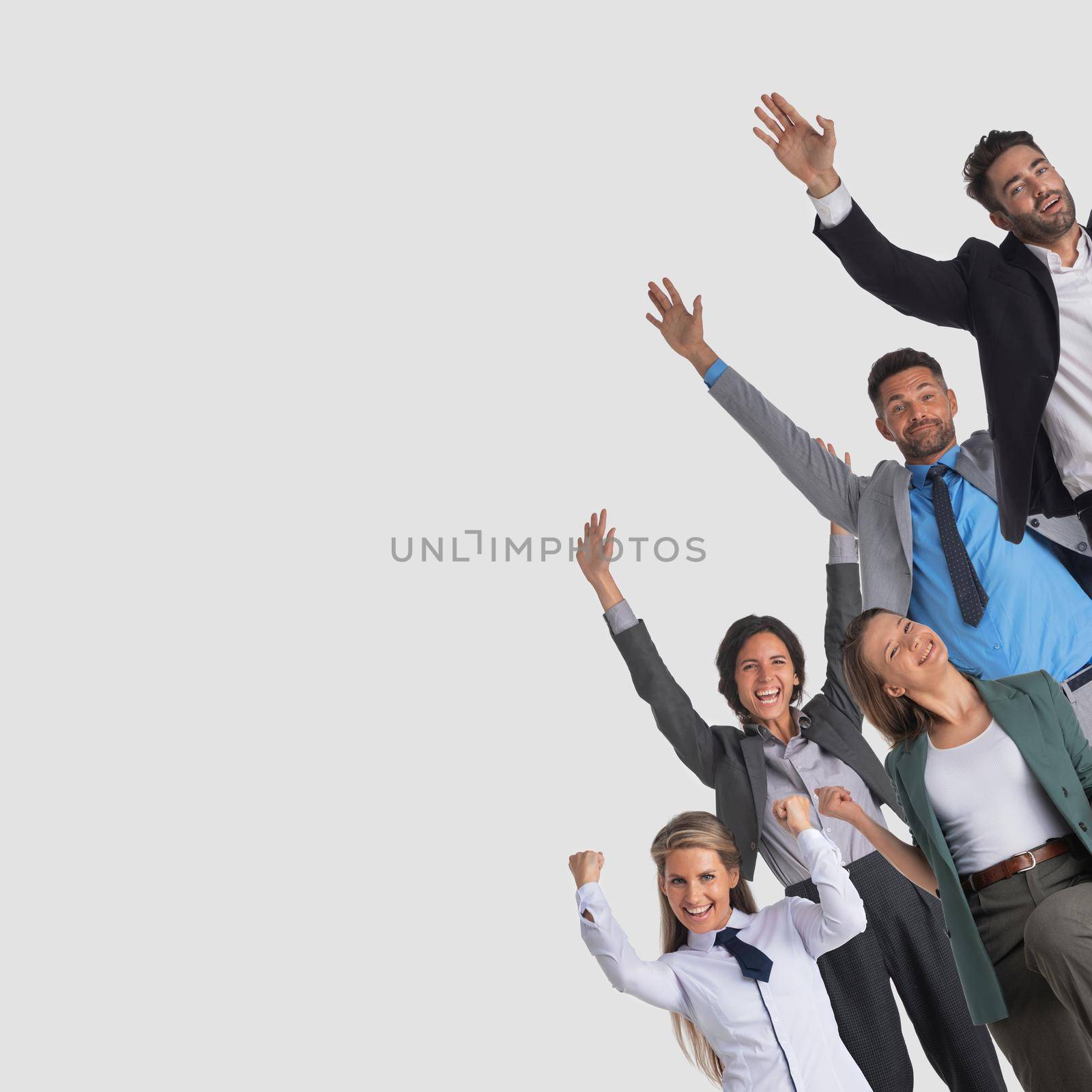 Successful excited business people group team, young businesspeople standing together smile hold fist ok yes gesture with raised hands arms, gray background
