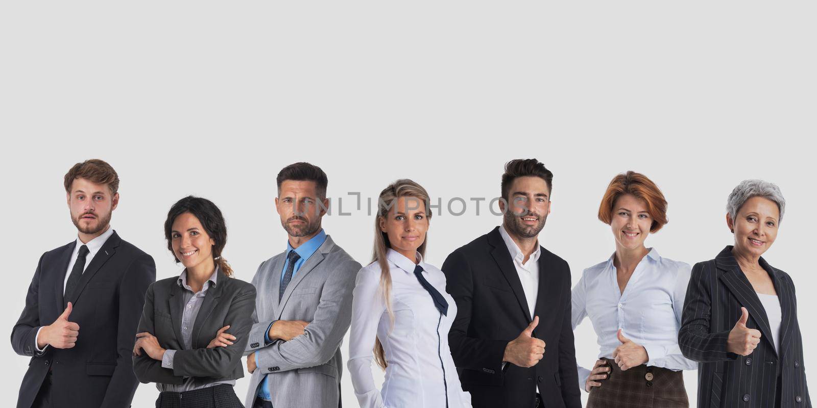 Group of business people with thumbs up sign standing together on gray background with copy space for text, unity cooperation teamwork concept