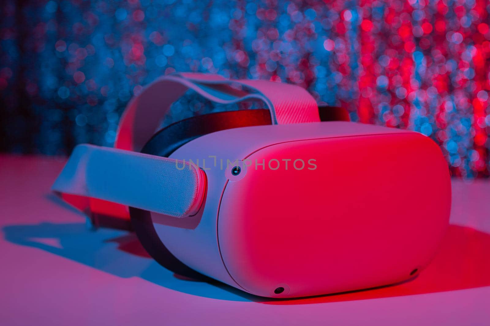 Virtual reality helmet on white background in neon light. VR technology concept. by galinasharapova