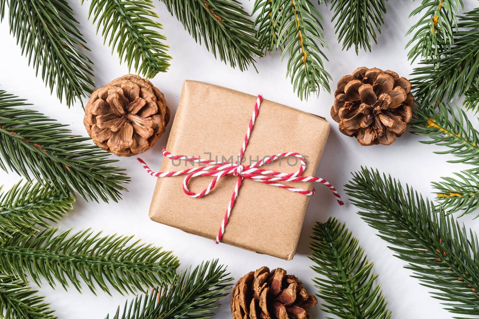 Christmas holidays zero waste paper giftbox wrapping with tag, pine cones and fir branches
