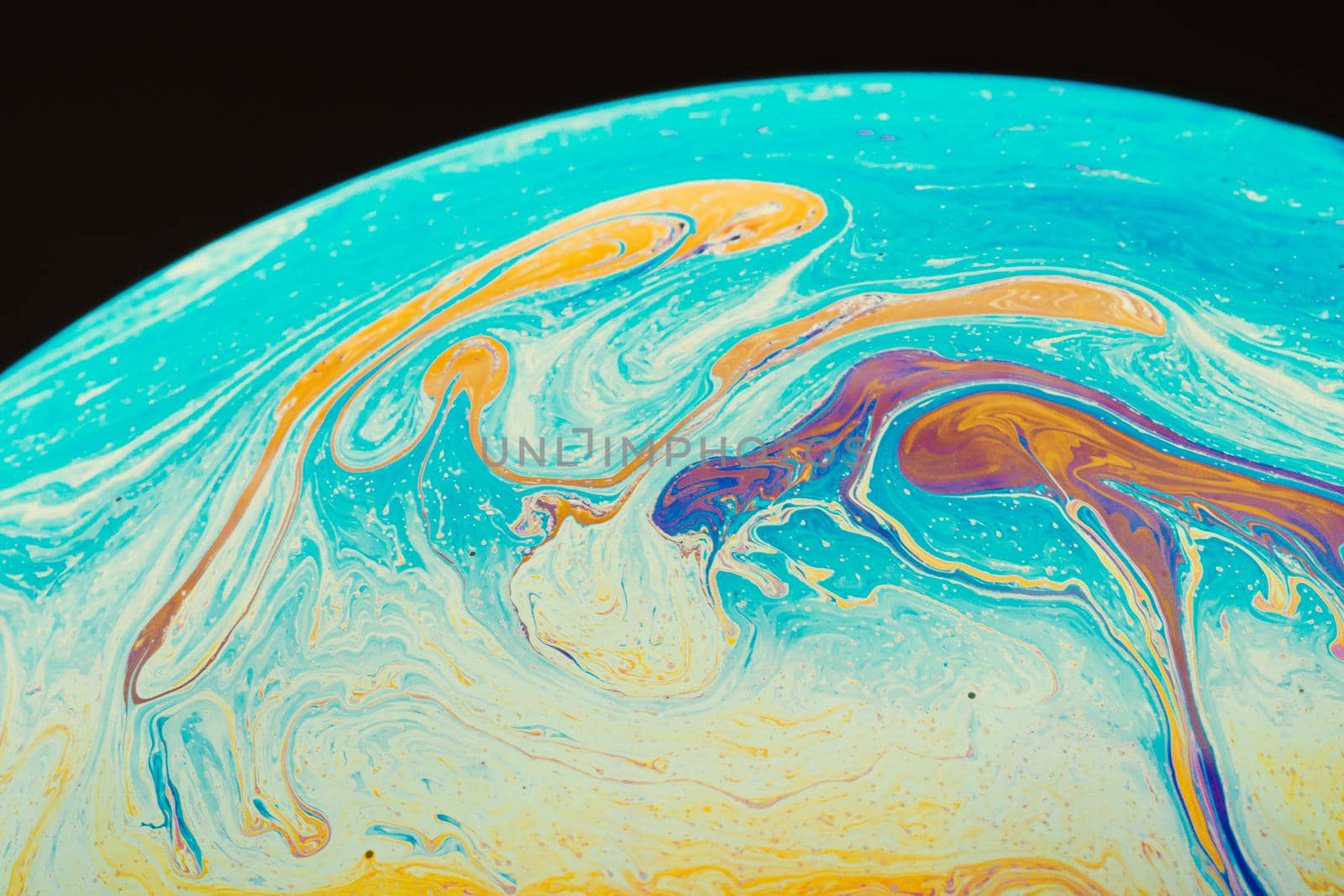 Fluid art made of colorful soap bubble film. Trendy Inkscape blurred background. Alien space planets art. Selective focus.