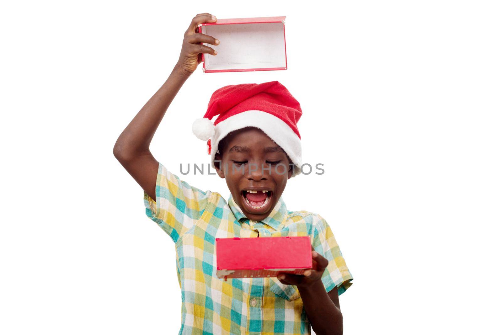 portrait of little boy in Santa Claus hat and happy opening the gift box of his gift.