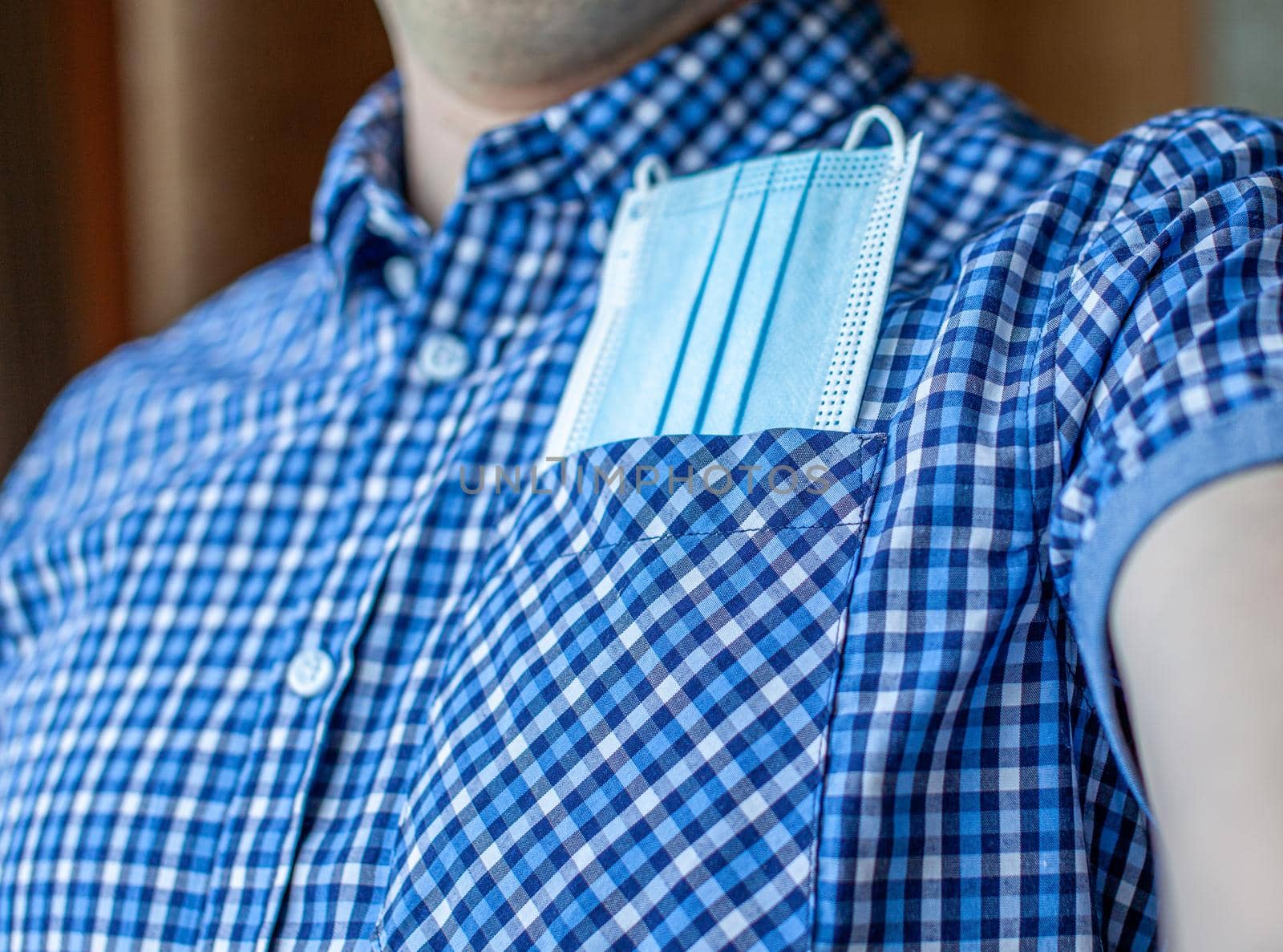 A man in a shirt, and in his pocket a medical mask from covid-19. The concept of tourism and travel in the new normal after the Covid-19, coronavirus. Life in the city and society during the pandemic