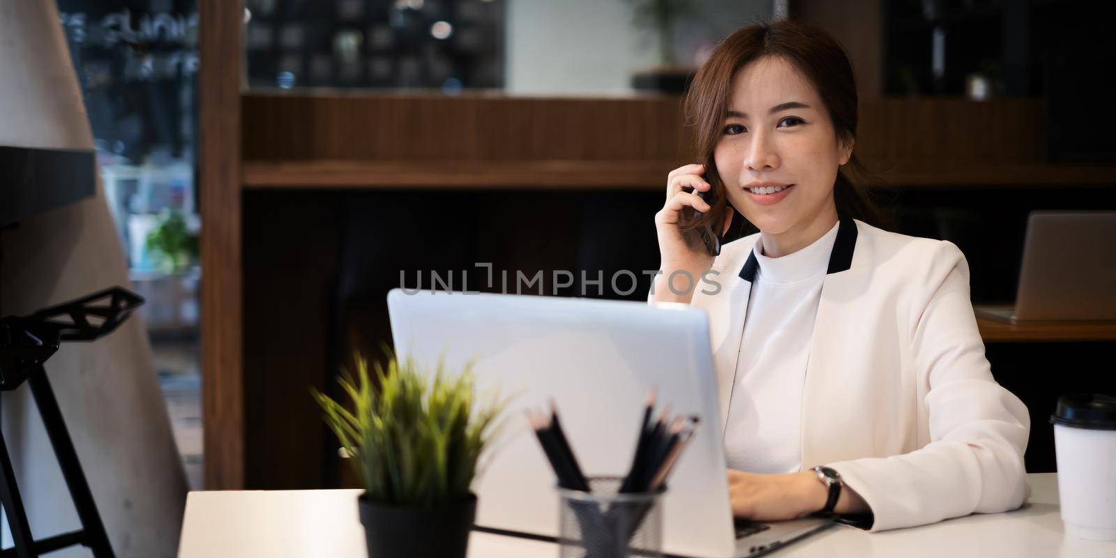 A successful organization as a manager is represented by a happy entrepreneur. Businesswoman talking with her exculsive customer. by itchaznong