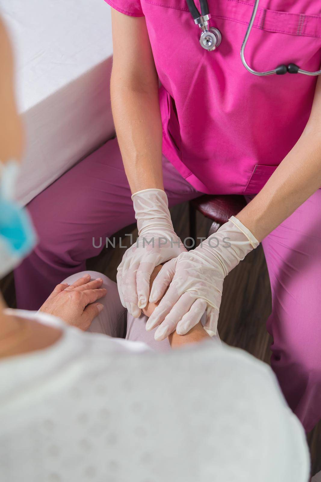 The girl the doctor reassures the woman about a good examination. The girl doctor smiles amiably at the patient. Health and medicine concept.