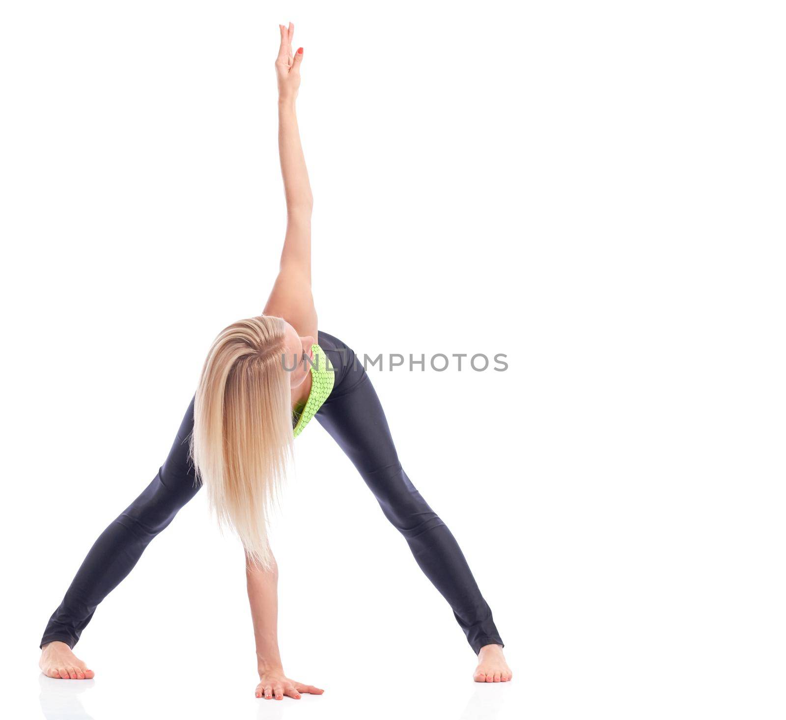 Exercising hard. Studio shot of a blonde sportswoman performing yoga at studio isolated copyspace on the side