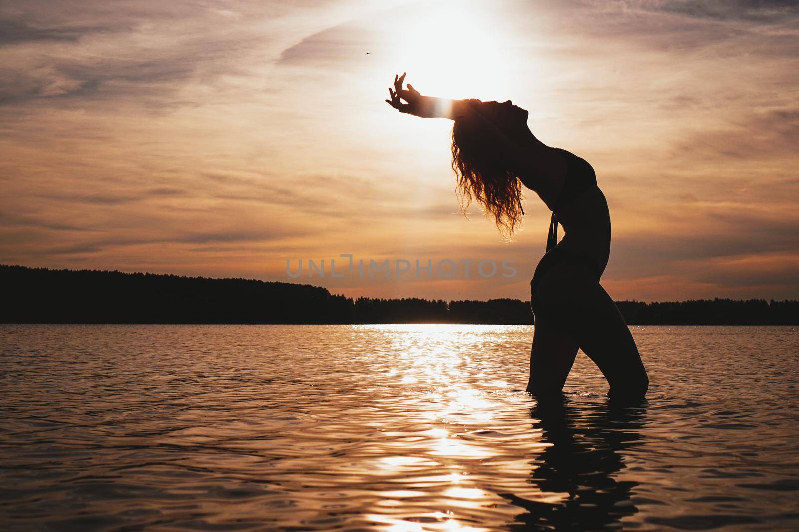 Happy Carefree Woman Enjoying Beautiful Sunset on the Beach - Summer photo