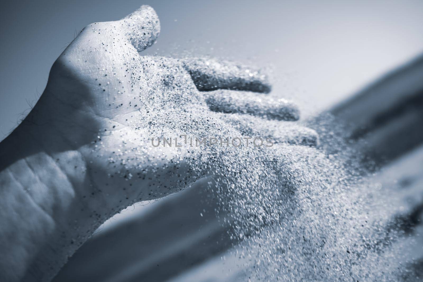 Sand flowing through the hand. Summer beach holiday vacation concept