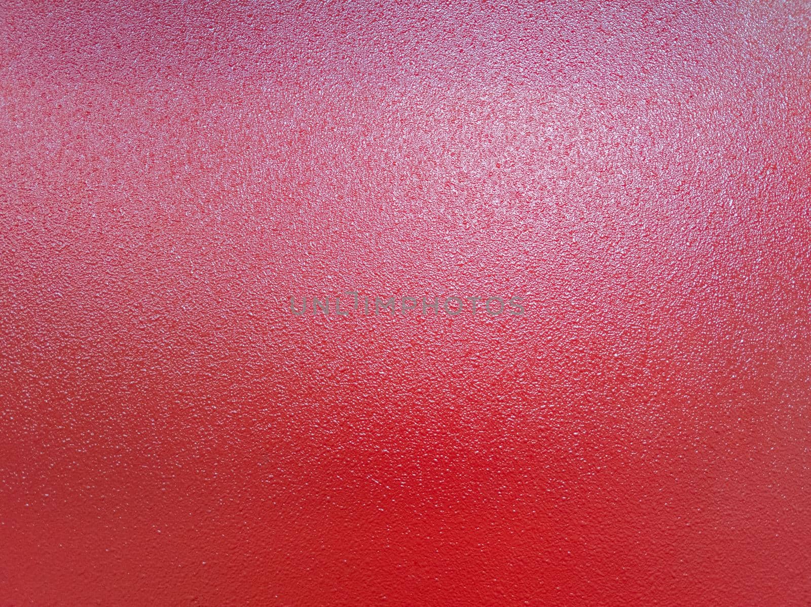 full frame bacground of red shagreen powder paint coating on flat sheet steel surface, industrial grade equipment coating