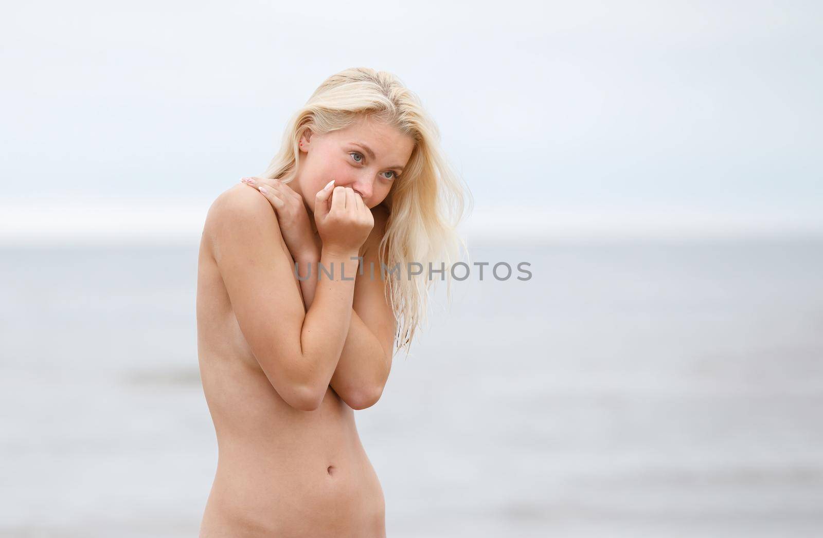 Portrait of a young naked woman on nature background by palinchak