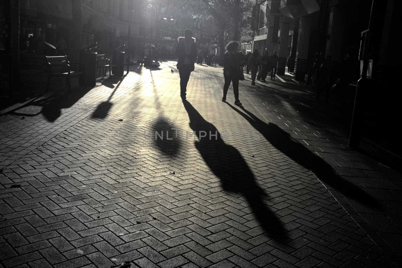Blurry shadows and silhouettes of pedestrian in the city at sunset, London,UK.