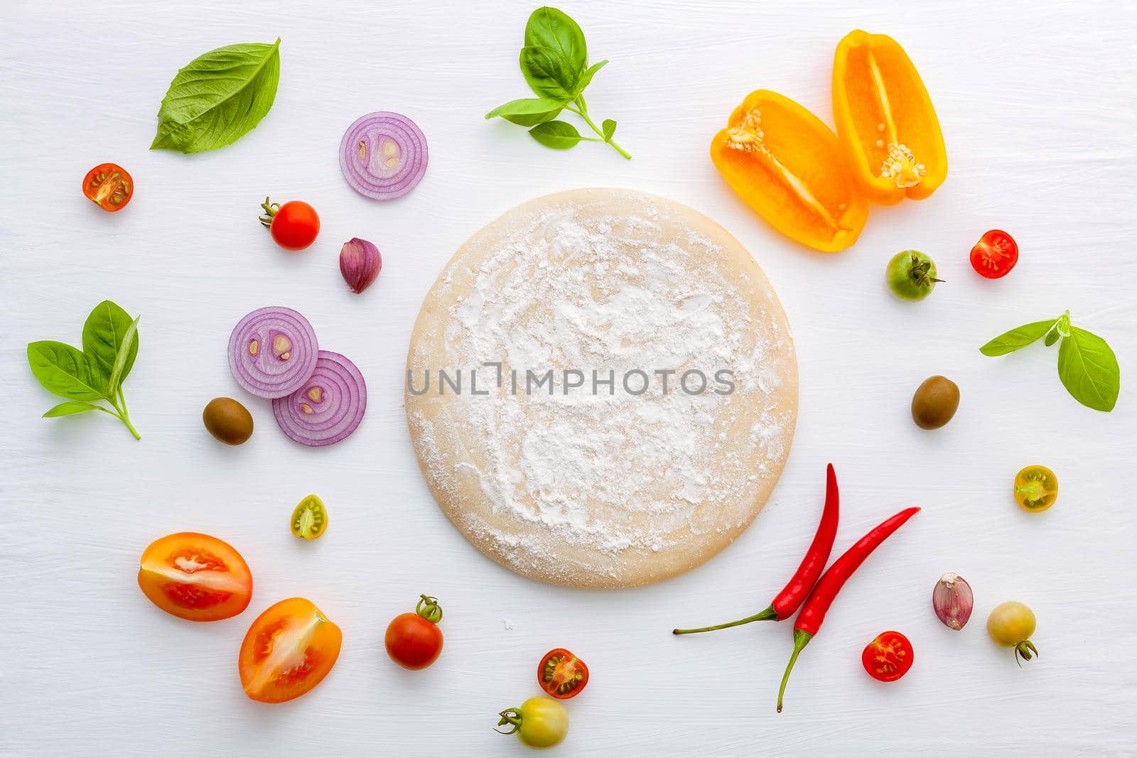 The ingredients for homemade pizza on white wooden background. by kerdkanno