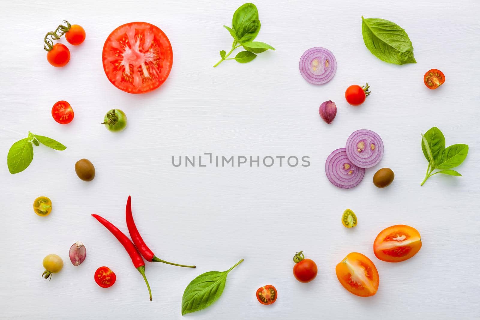 The ingredients for homemade pizza on white wooden background.