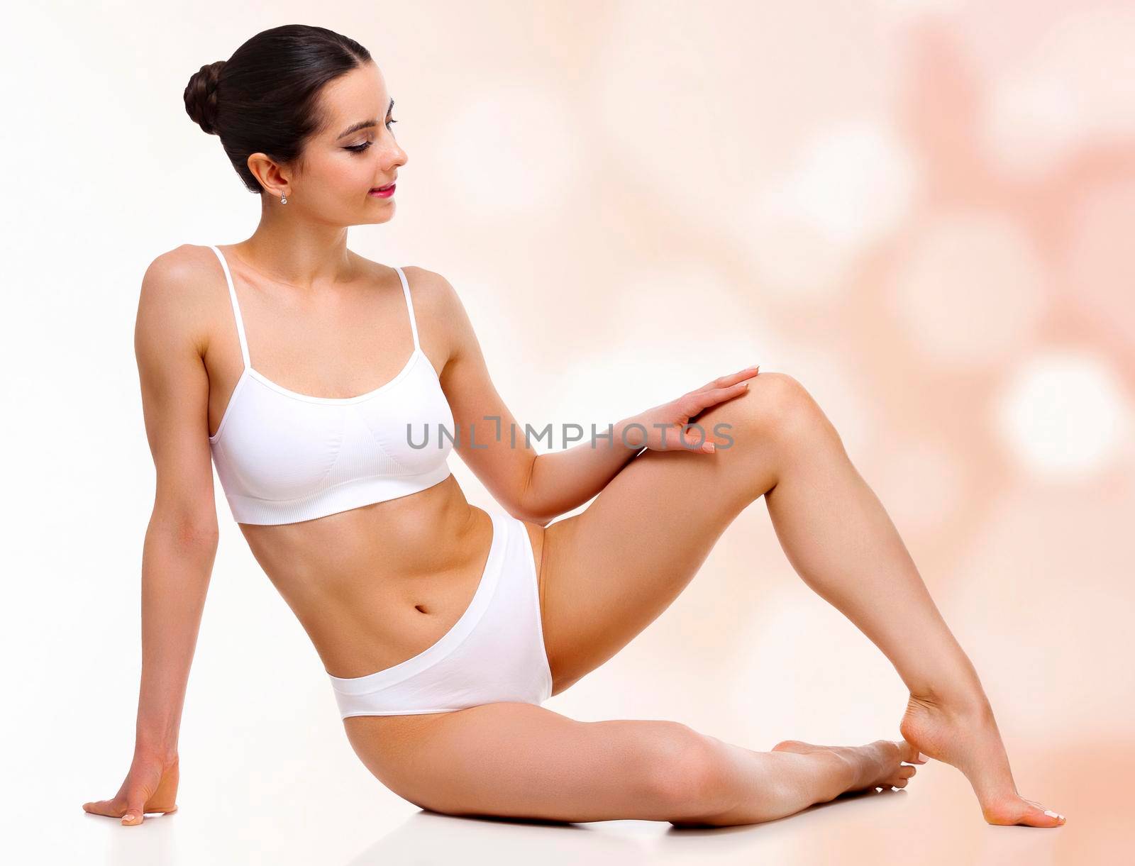 Young woman with slim body and smooth clean skin against an abstract background with circles and copyspace by Nobilior