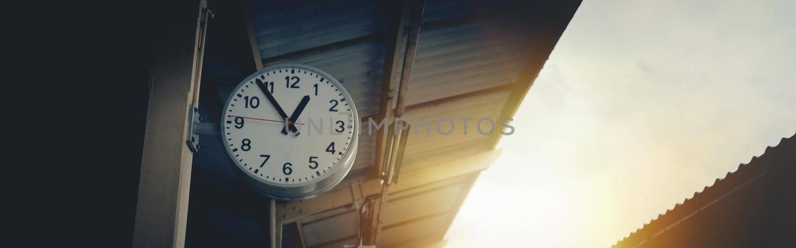 Retro Vintage Clock at Train Station and Banner background sunlight. by pravinrus