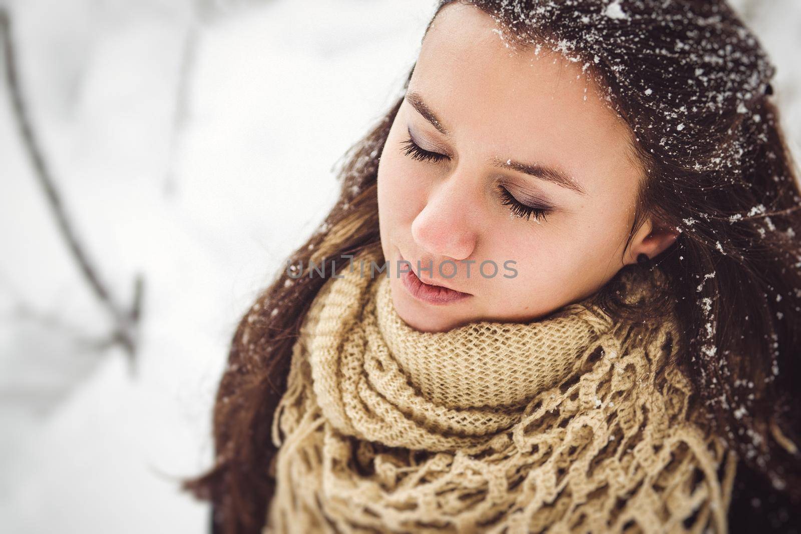 girl in warm clothes and scarves on a walk in the snowy forest and in the field by Andreua