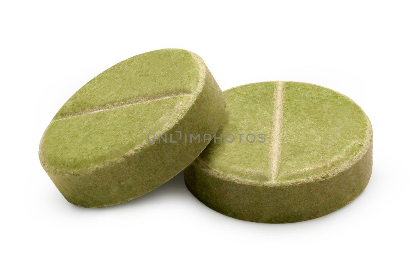 Two green herbal pills isolated on white background. Close-up macro view