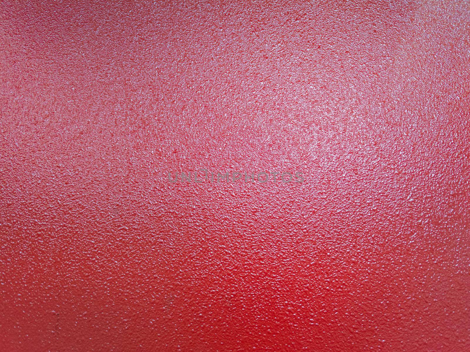 full frame bacground of red shagreen powder paint coating on flat sheet steel surface, industrial grade equipment coating