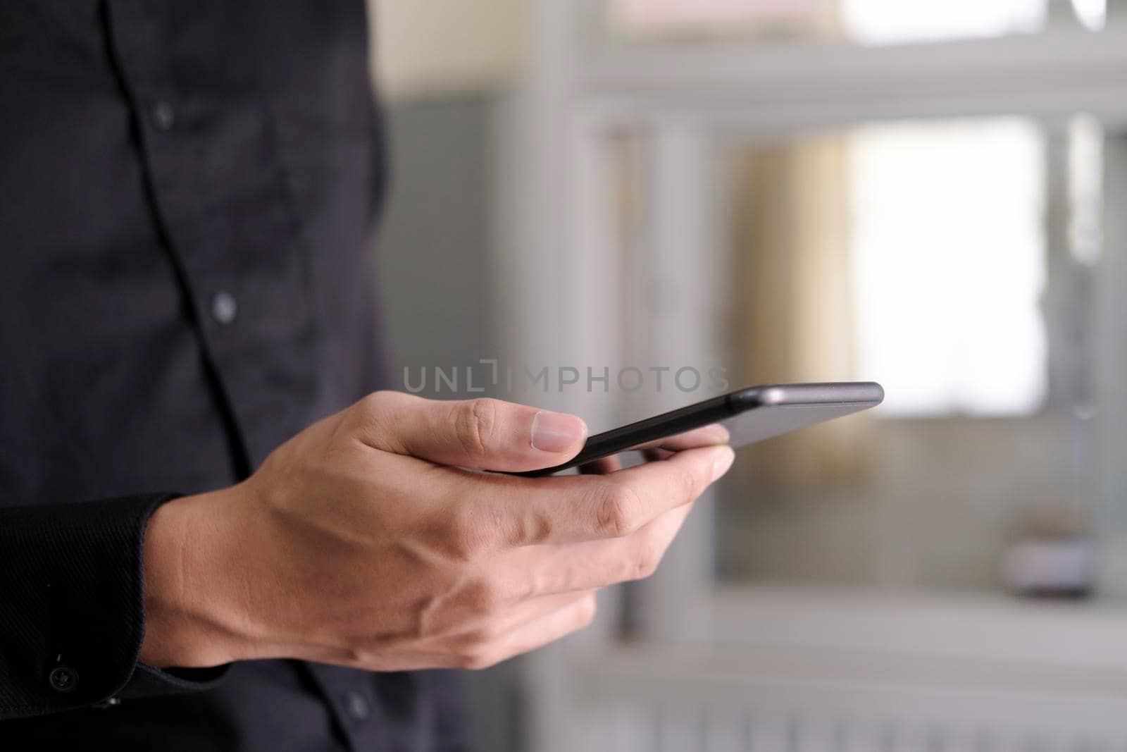 Young man using mobile phone. Using online connect technology for business, education and communication. 