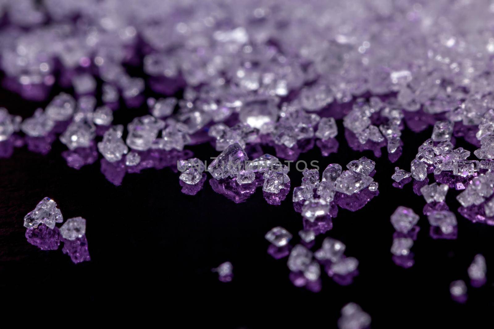 White sugar crystals on a dark violet background by clusterx