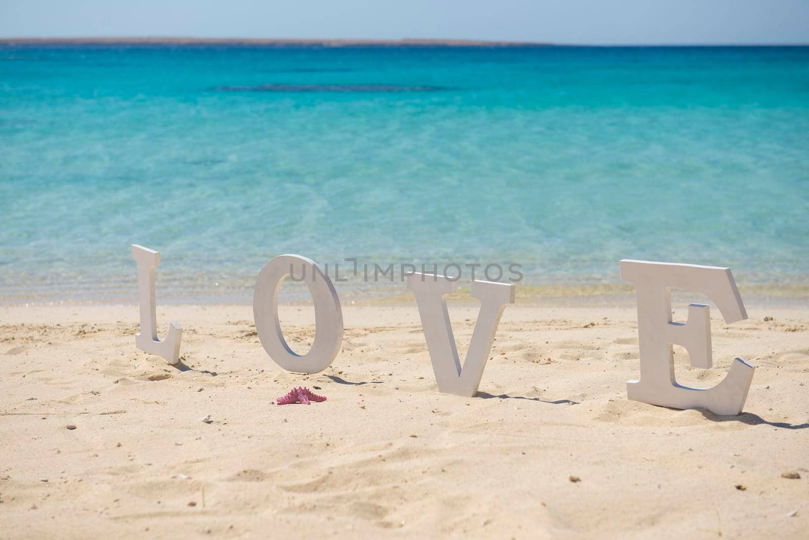 Romantic love sign on a tropical beach paradise by paulvinten