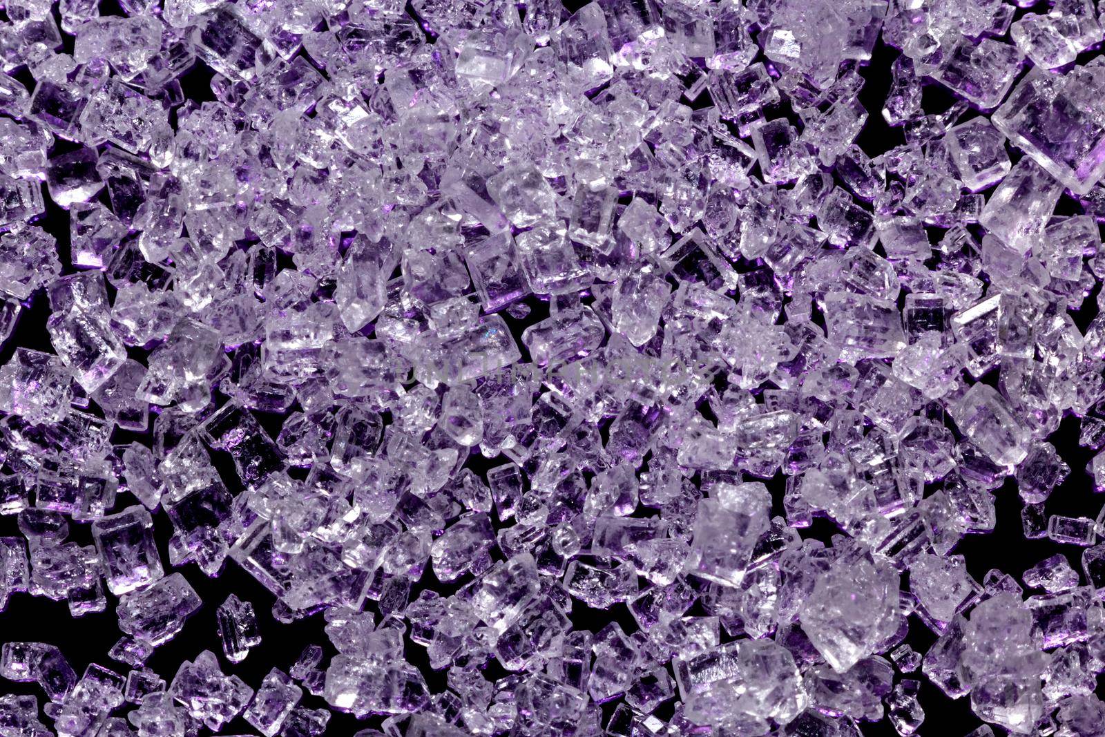 White sugar crystals on a dark violet background, macro, close-up