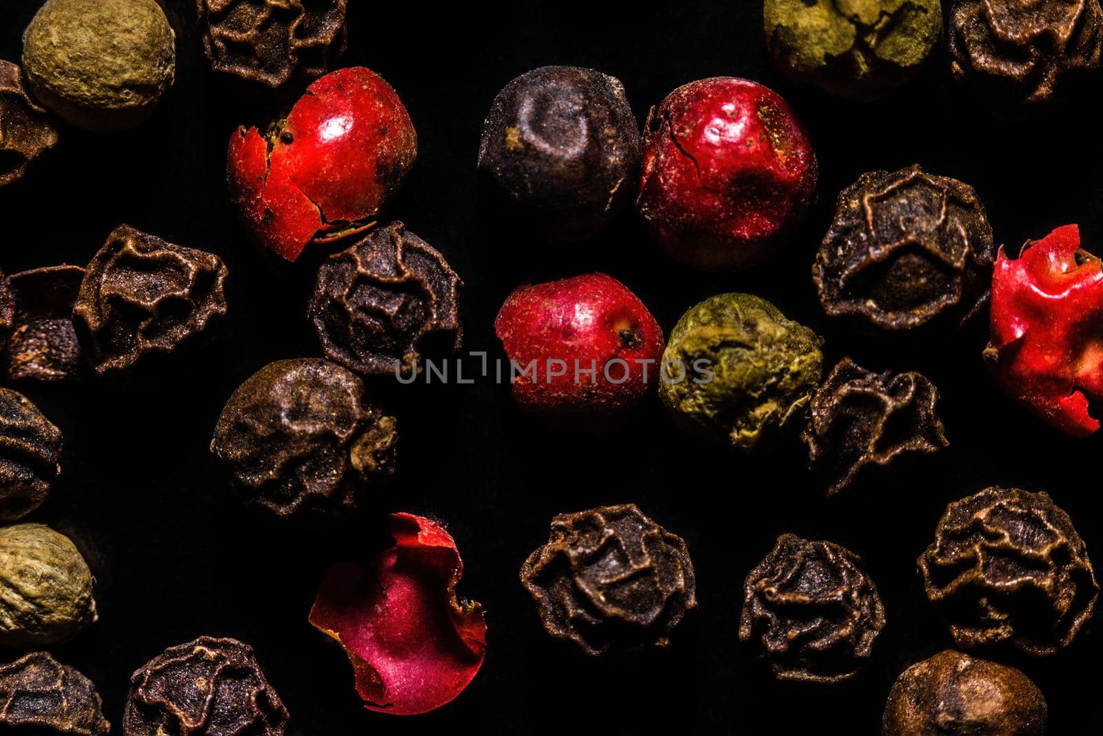 Colored dried pepper mix on a dark background, macro, close-up