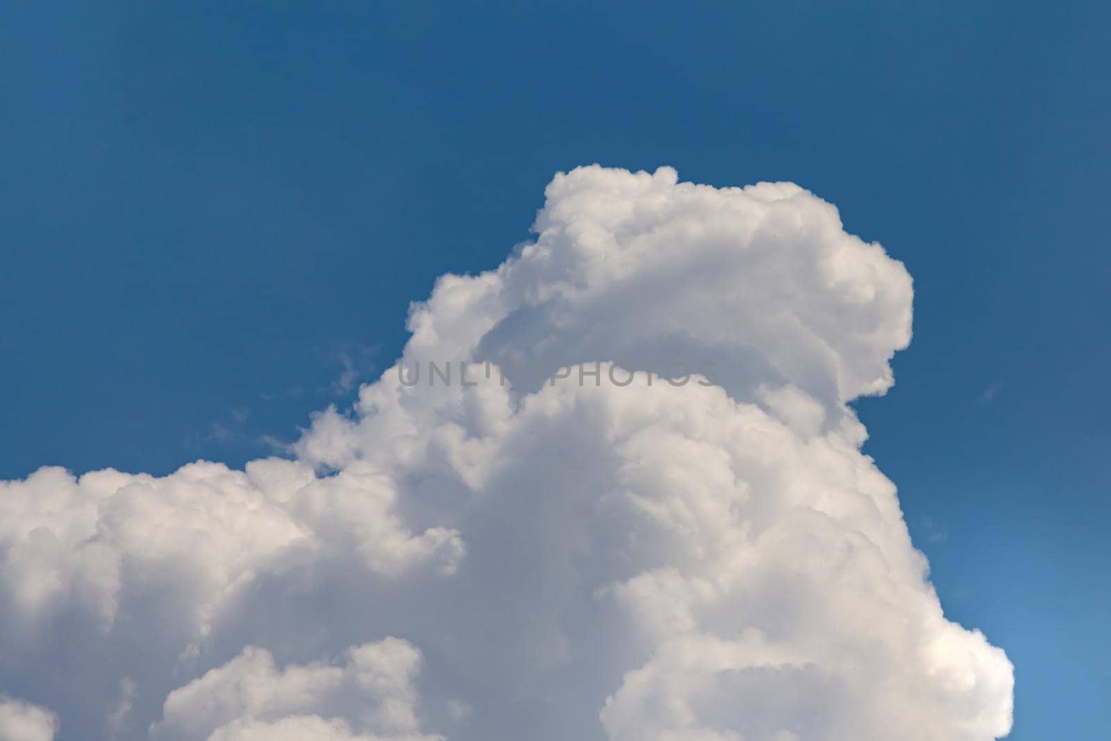 Huge cumulonimbus high in the blue sky by clusterx