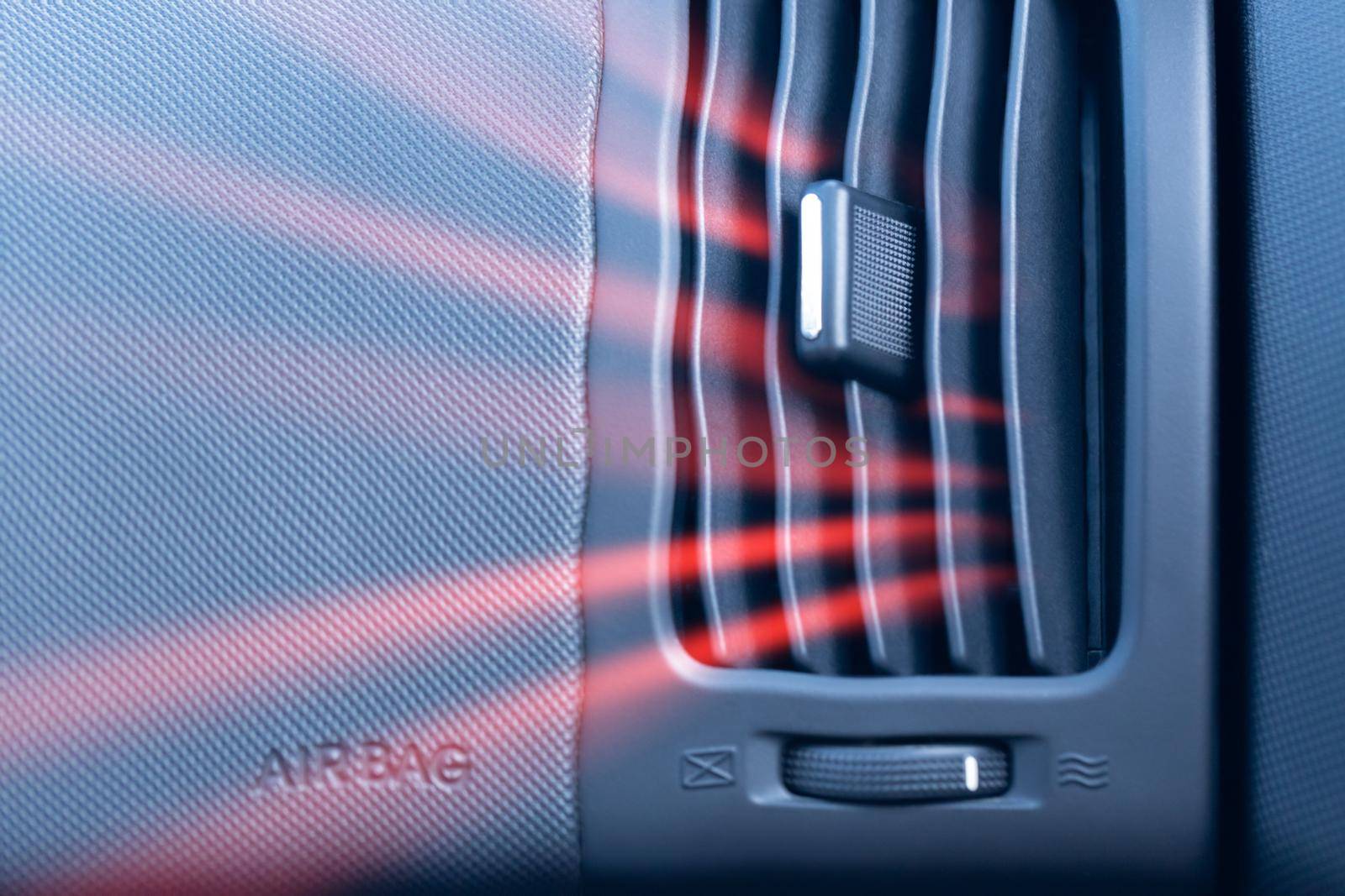 Car air conditioner with illustration of hot air flow from it. Front view close up by clusterx