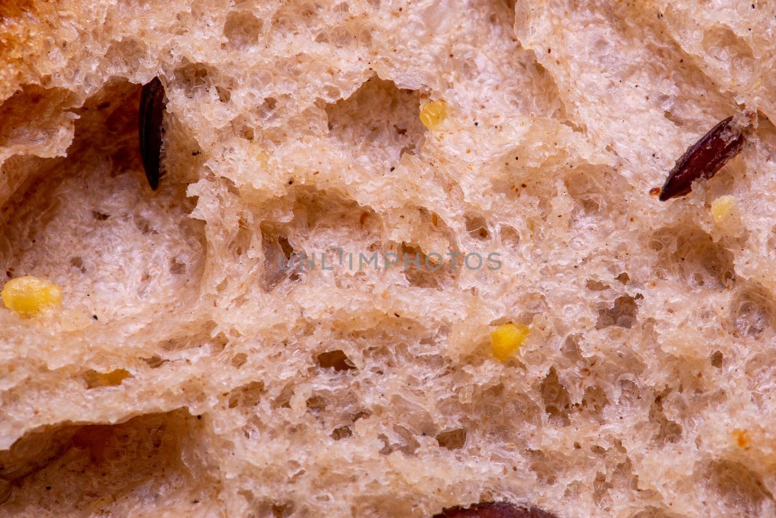 Wheaten white bread loaf texture with seeds, close-up macro shot