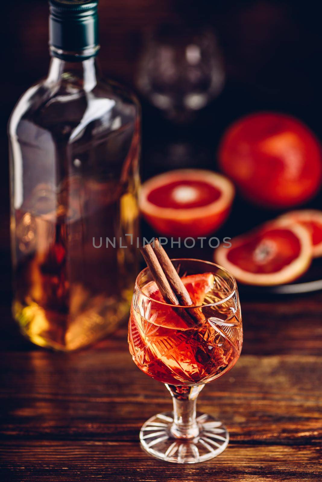 Blood orange whiskey sour cocktail with aged bourbon, blood orange juice, cherry syrup and cinnamon