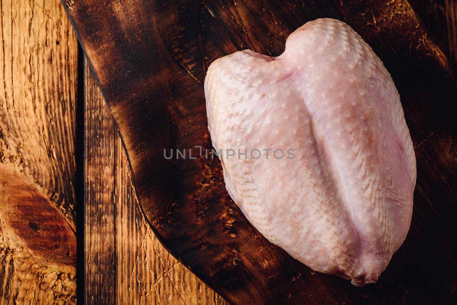 Raw chicken breast on chopping board by Seva_blsv