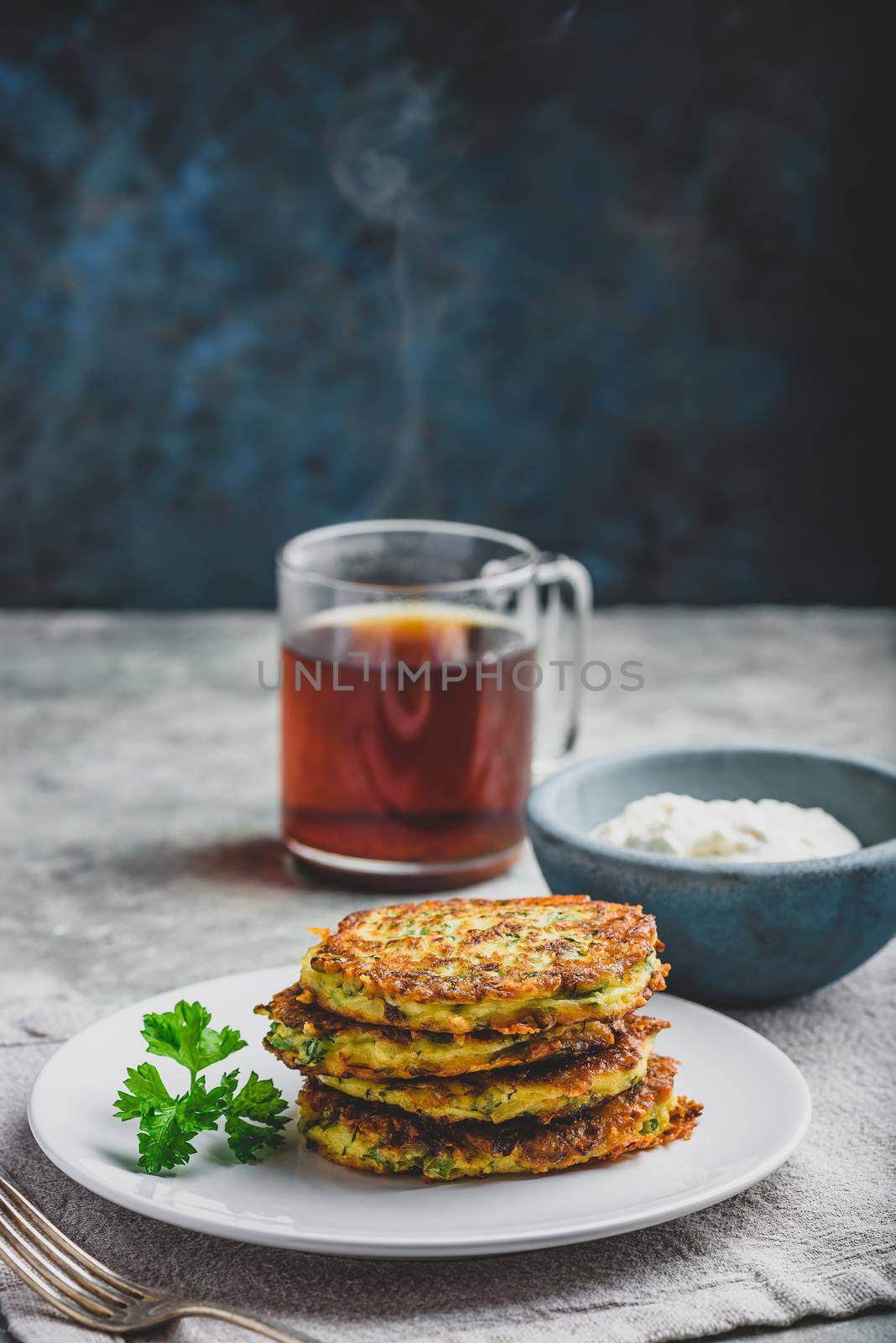 Zucchini parmesan pancakes with dip and parsley