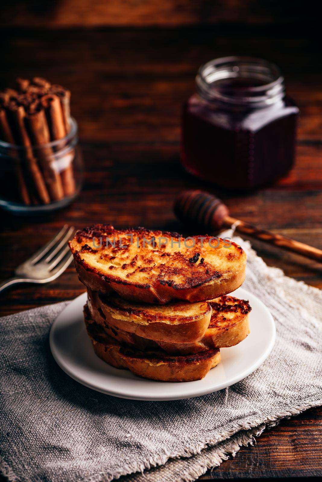 French toasts on white plate over wooden surface