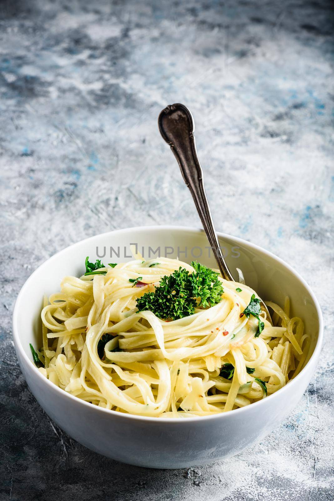 Easy lunch recipe. Linguine pasta with olive oil, garlic, fresh parsley and grated parmesan cheese.