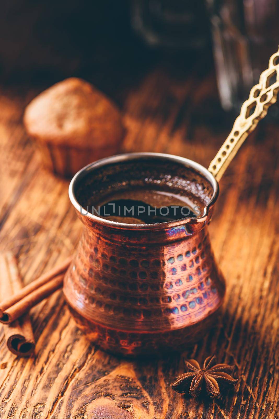 Turkish coffee with spices and oatmeal muffins on wooden surface